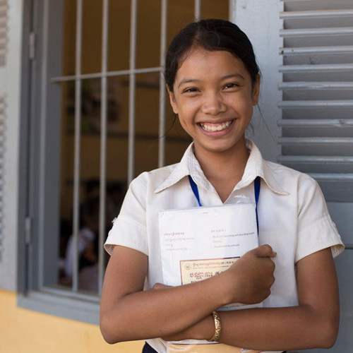 Girl holding books smiling