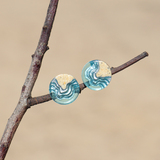 Shoal ear studs on branch