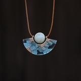 Reef curved beach necklace on black background