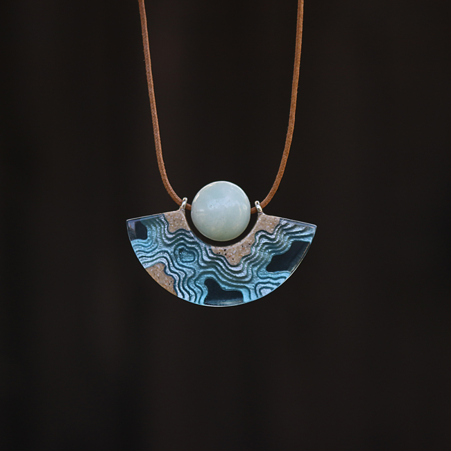 Reef curved beach necklace on black background